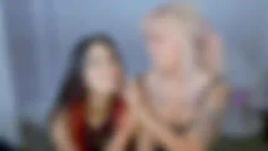 Two girls in medical gloves open wide mouths