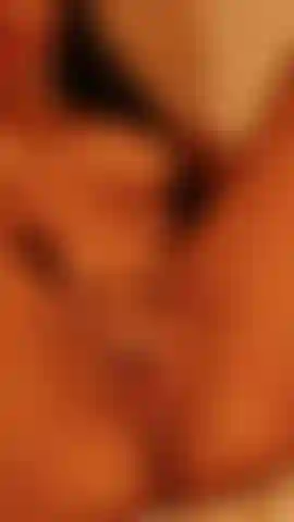 A close-up of my pussy, open and pink, as I rub my clitoris