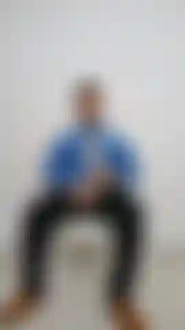 In blue shirt and black pants