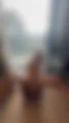 Putting my big dildo inside myself while people from the office block watch me