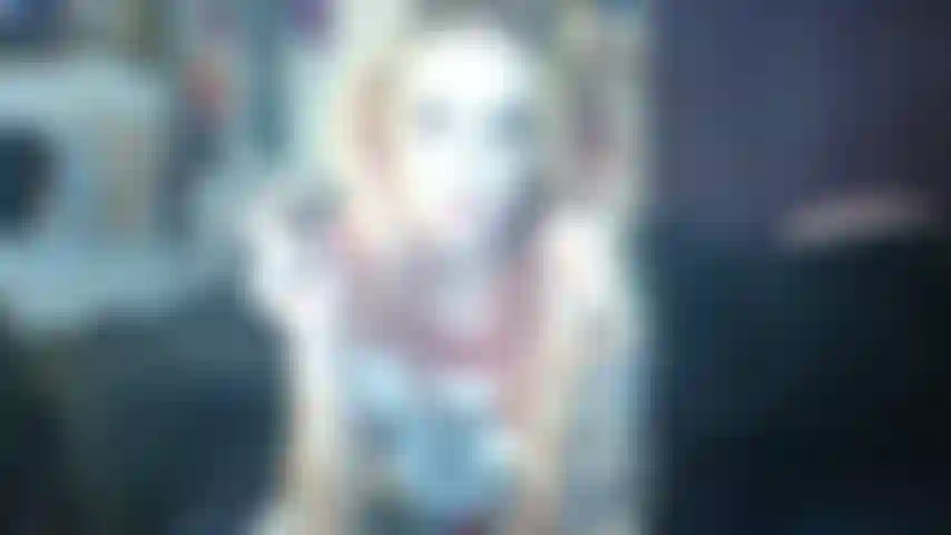 Cosplay de harley quinn fuma para você, sopra fumaça na cara. Mostra os peitos.