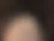 Com um body de nylon preto transparente e meia-calça brilhante.