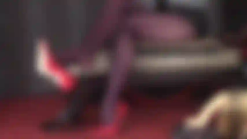 Legs that impress - A very sensual intimate tease in opaque brown tights and red steel heel pumps dangling from Mistress' toes.