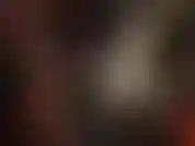 Uma linda amante de pvc com um casaco longo de vinil brilhante, luvas e botas de cano alto.