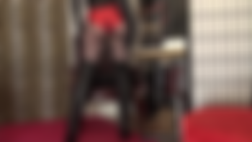 A mistress está deixando você babando por esse traje fantástico de shorts vermelhos metálicos, meia-calça preta e botas longas de couro.