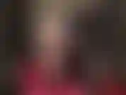 Usando um body preto brilhante de pvc e meia-calça preta transparente.